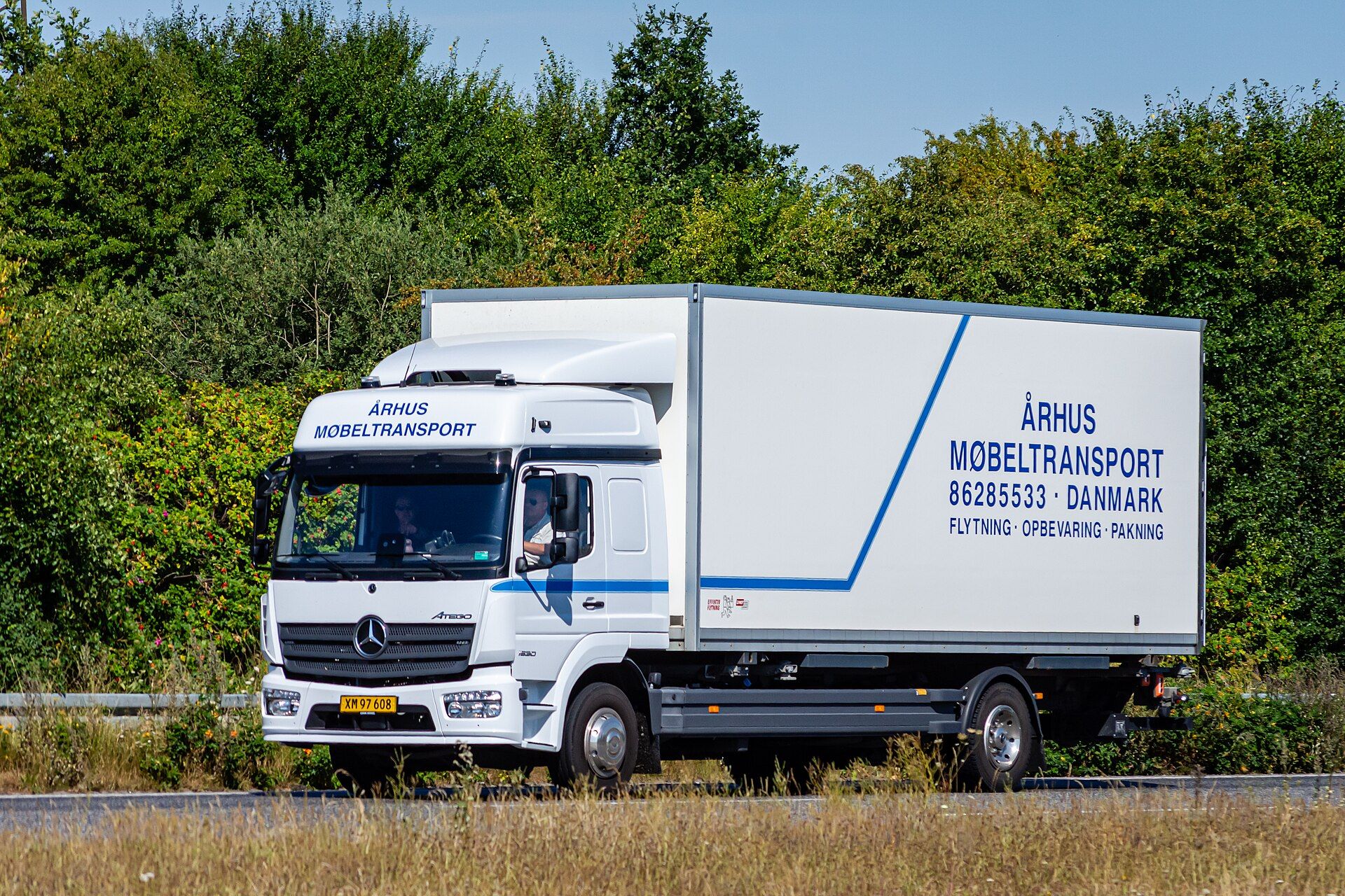 White Mercedes-Benz Atego 1530 4x2 rigid with a box body and an L-cab, on a Danish road