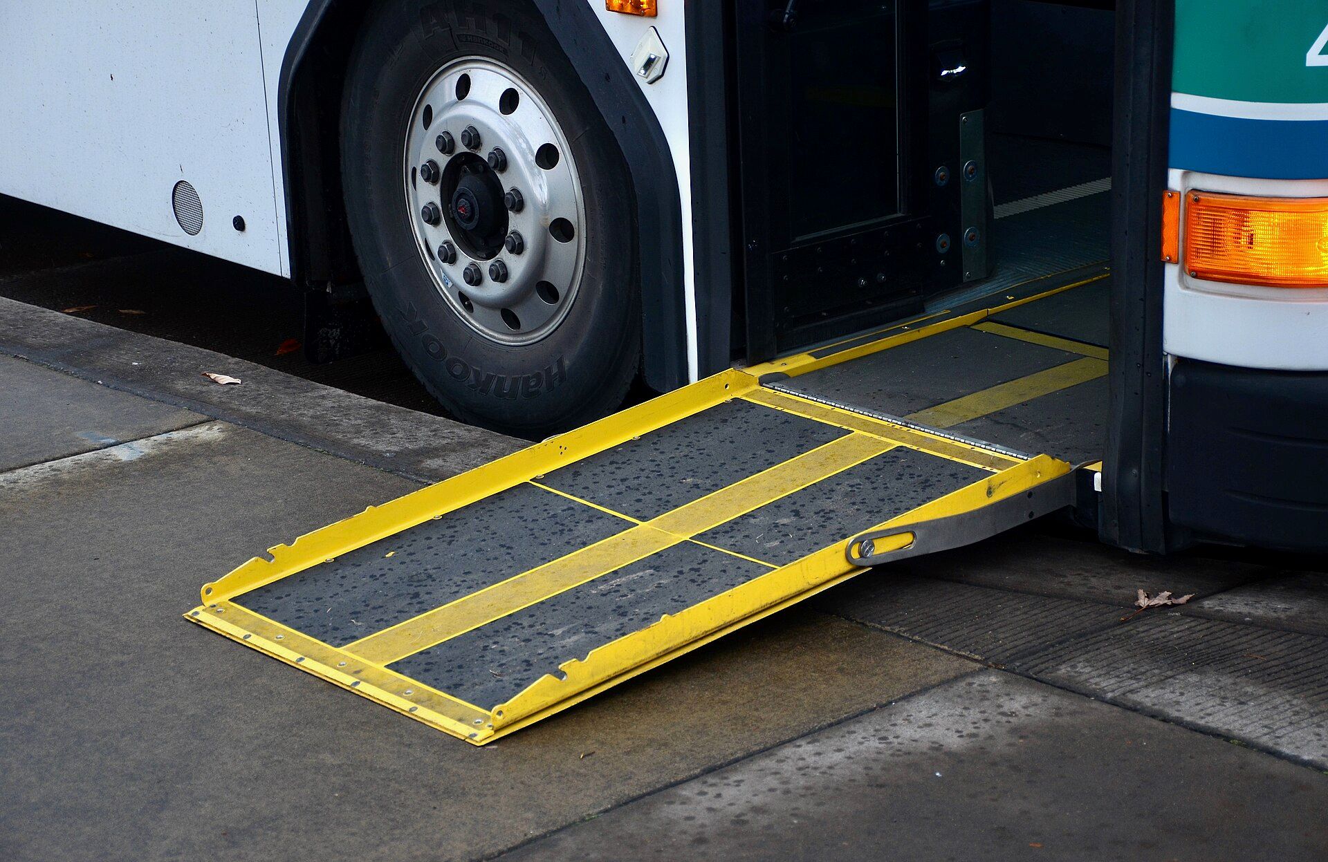 Wheelchair ramp deployed at the front door of a low-floor city bus