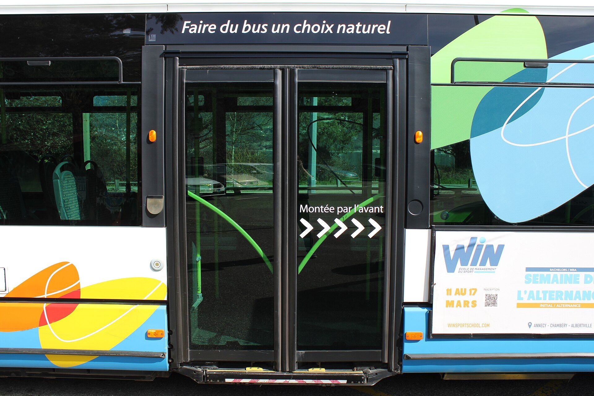 Closed double service door in the side of a city bus, with the wheelchair ramp flap set into the door aperture