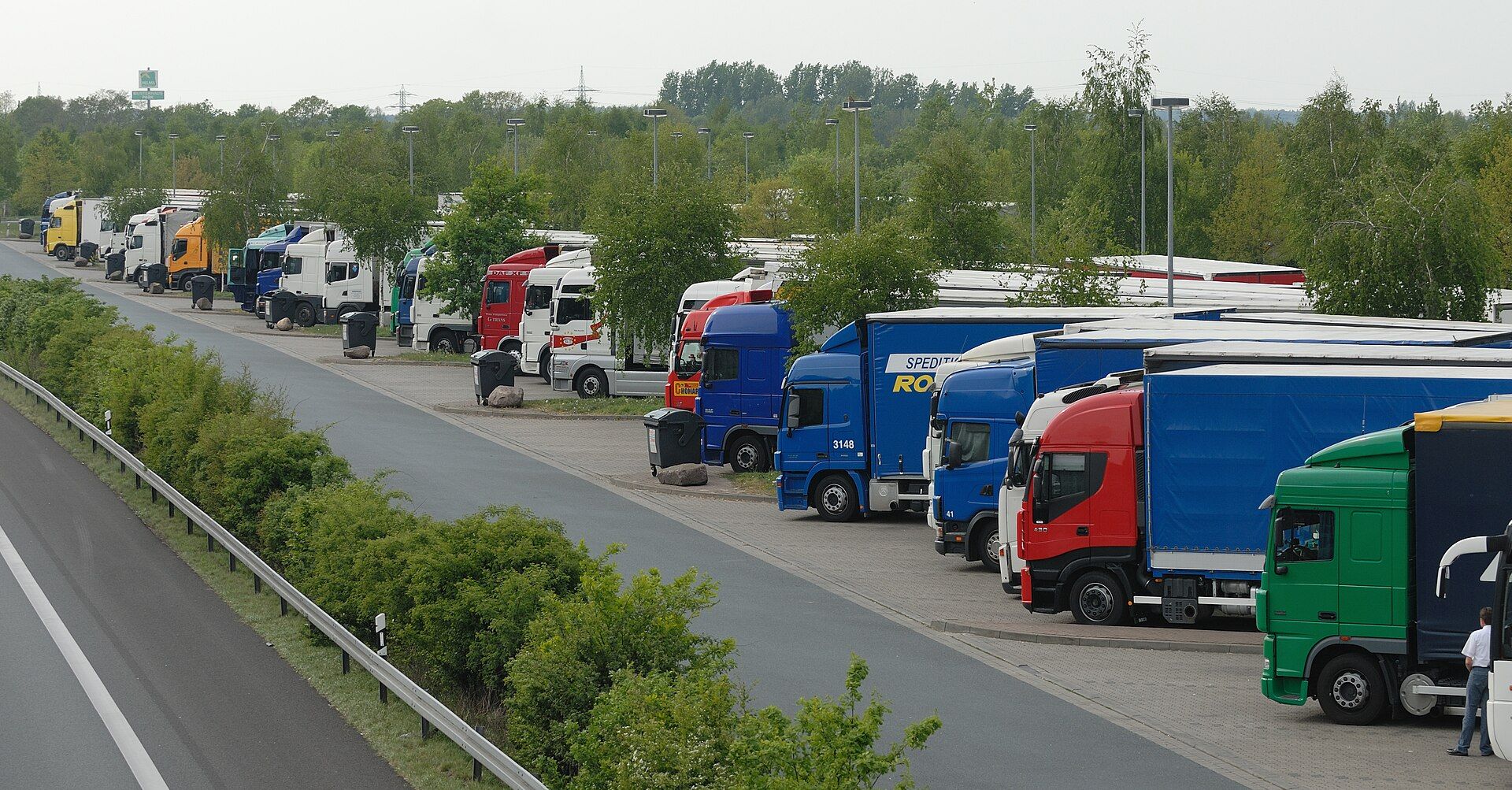 Rows of tractor units and curtainsiders parked at the Lehrter See service area on the German A2 motorway