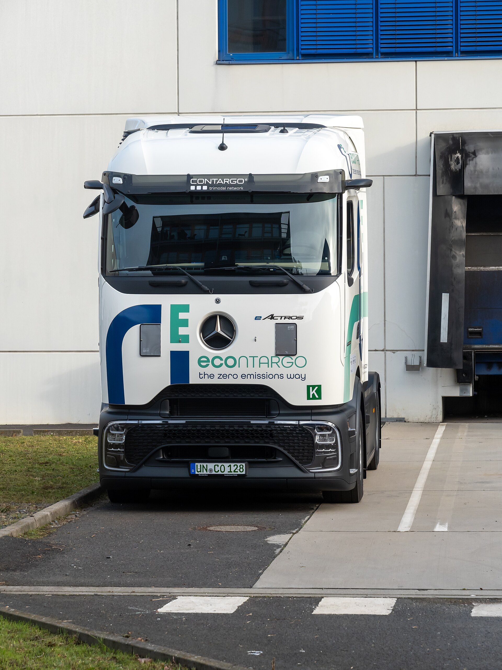 White Mercedes-Benz eActros tractor unit in econtargo livery at a loading dock in Frankfurt