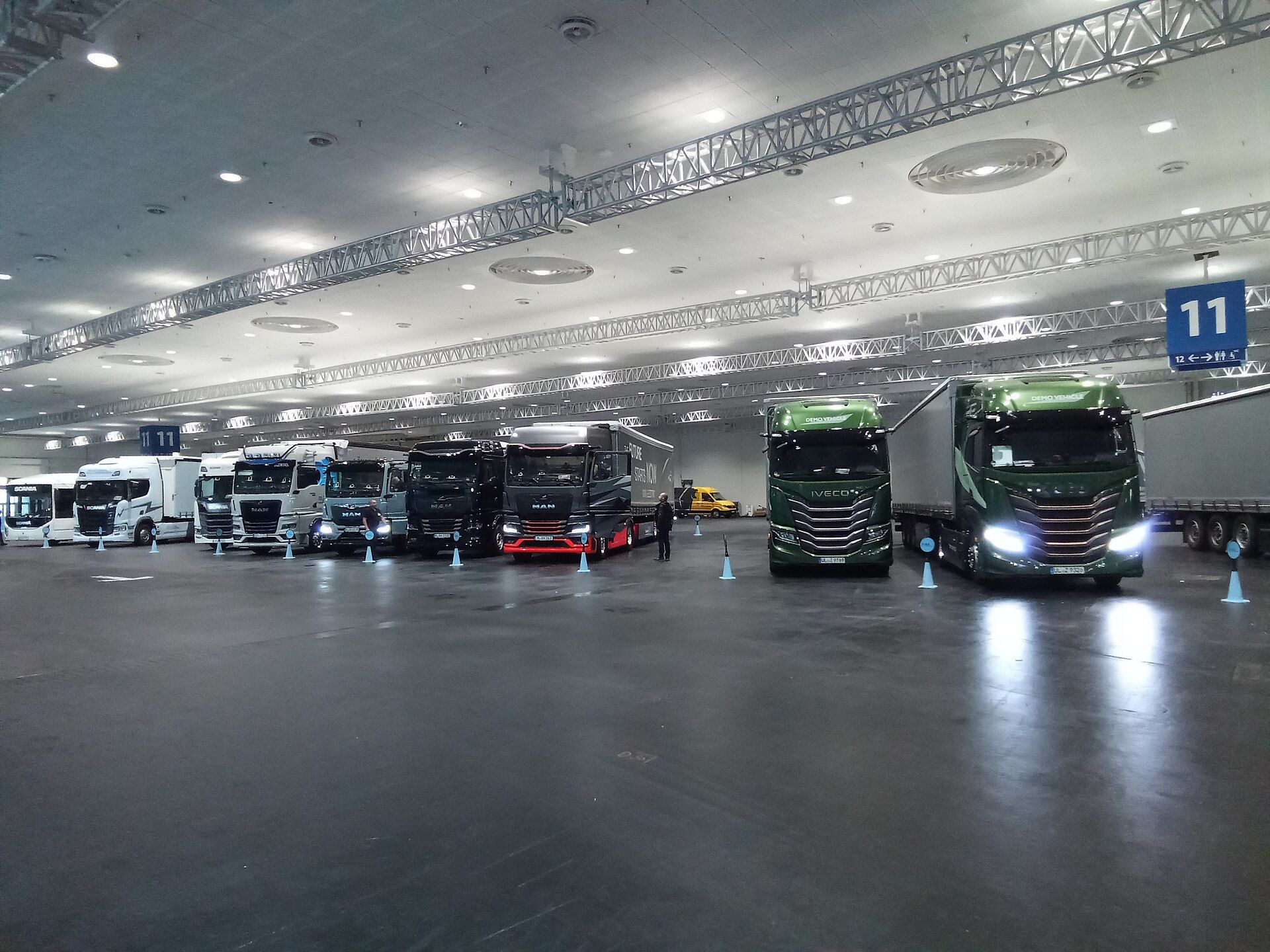 A line-up of new Scania, MAN and Iveco tractor units parked in an exhibition hall at IAA Transportation 2024 in Hanover